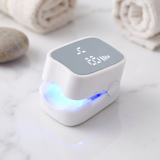 Kler Dual-Light Nail Renewal Device on marble